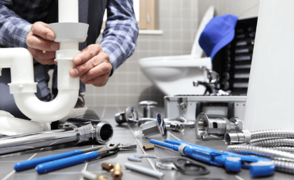 a close-up of a man fixing a pipe